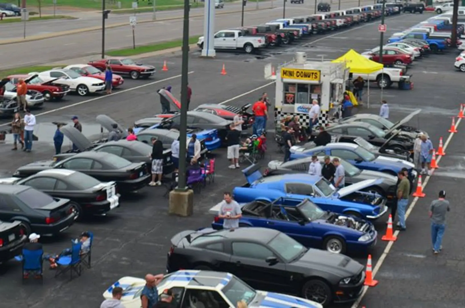 Parking lot filled with vintage cars display