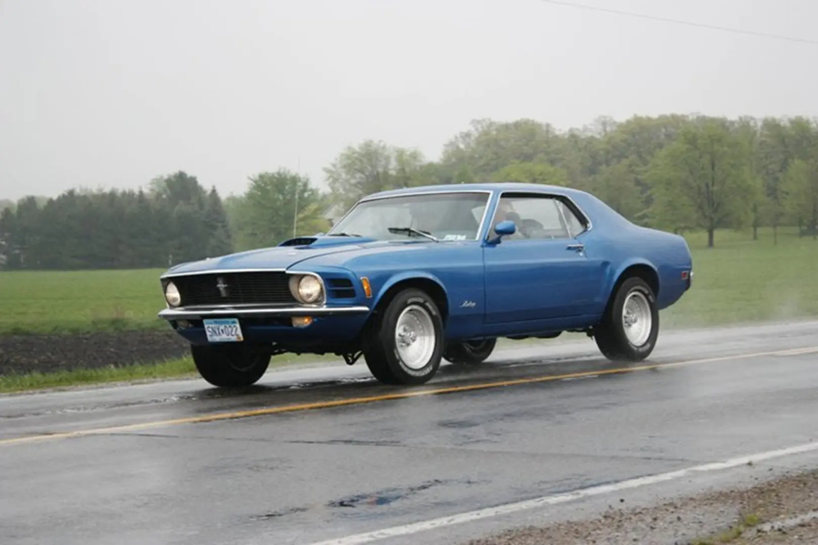 Retro blue car in wet weather