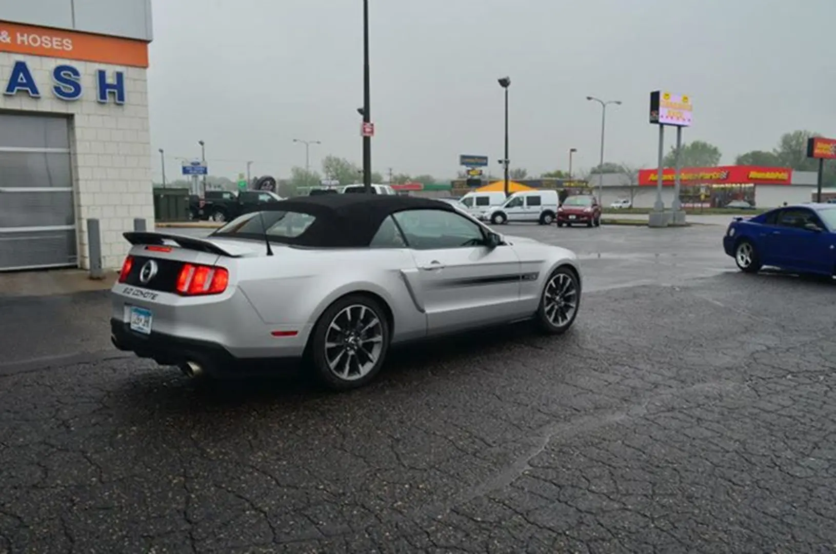Mustang parked on wet pavement