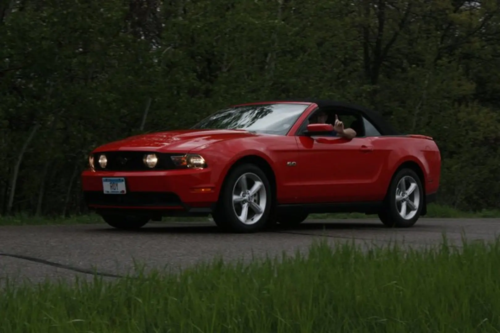 Sports car cruising through scenic greenery