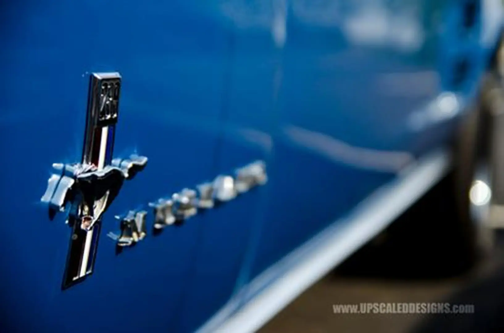 Close-up of blue classic car emblem