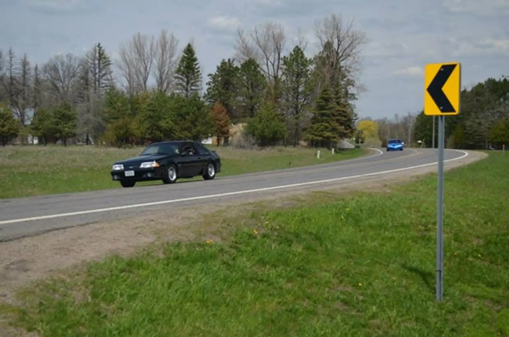 Cars on a rural road curve
