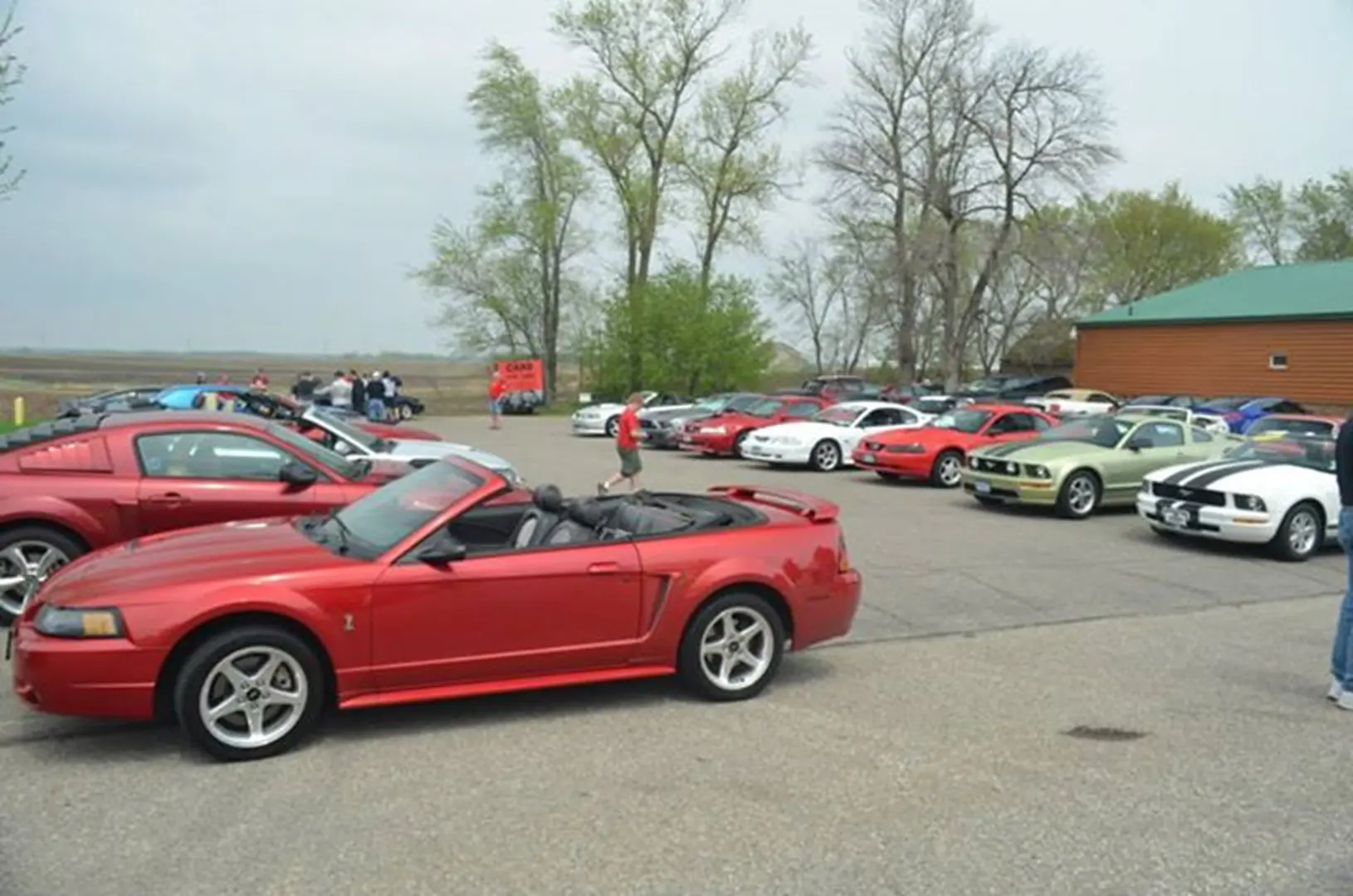 Red convertible and classic cars gathering