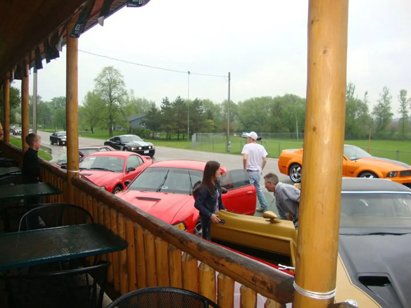 Group gathered around vibrant sports cars