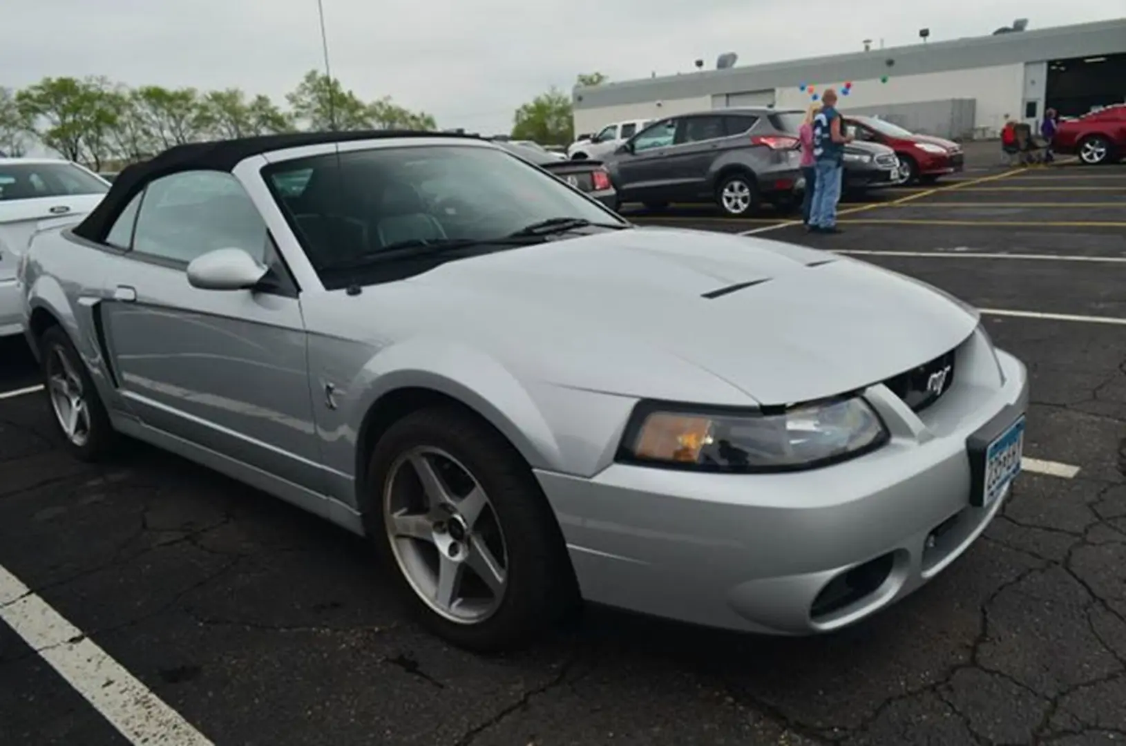 Silver convertible sports car in parking lot