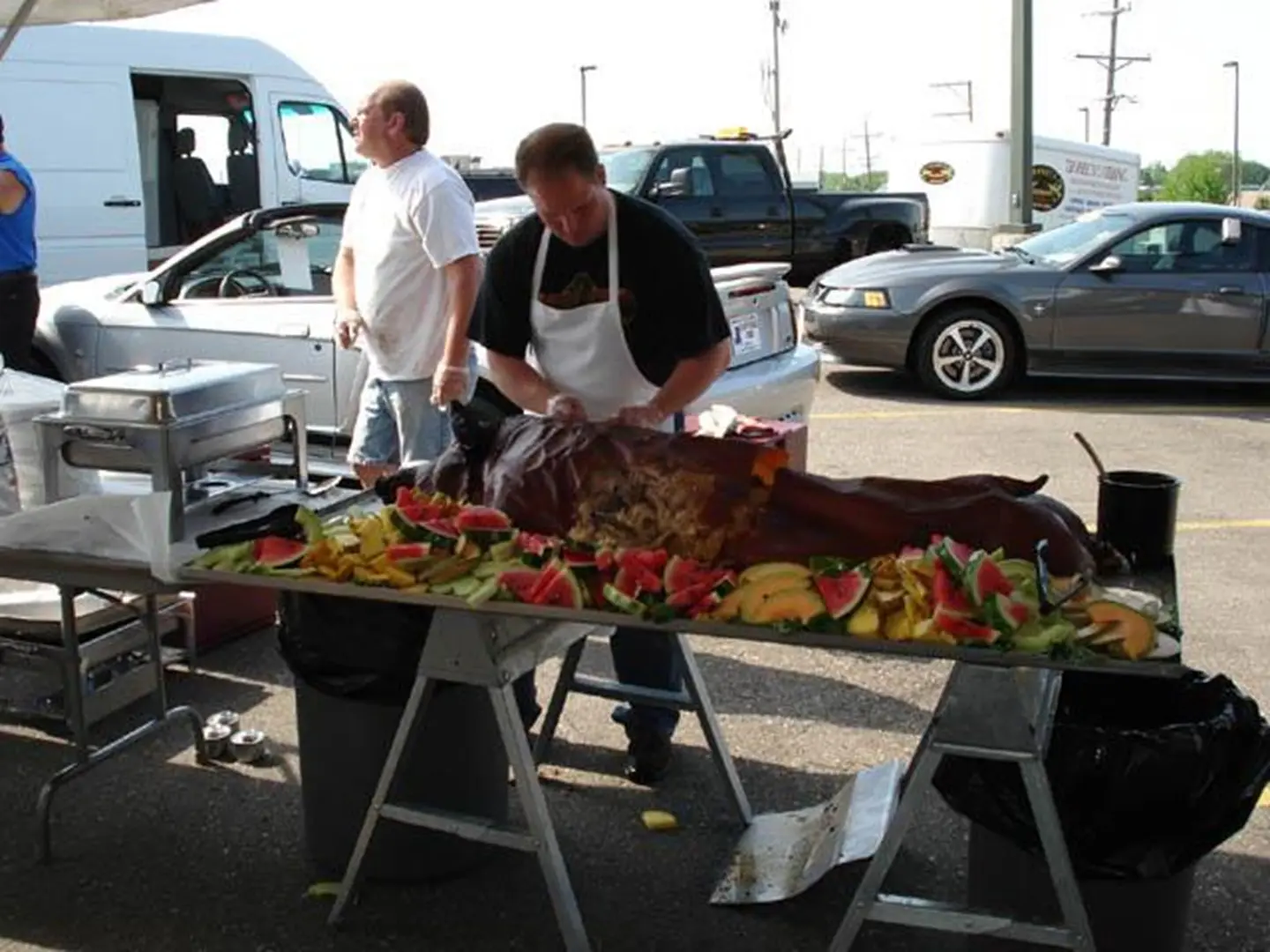 Outdoor barbecue with whole roasted pig