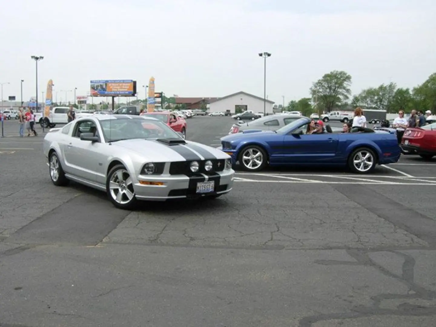 Silver and blue cars in parking lot