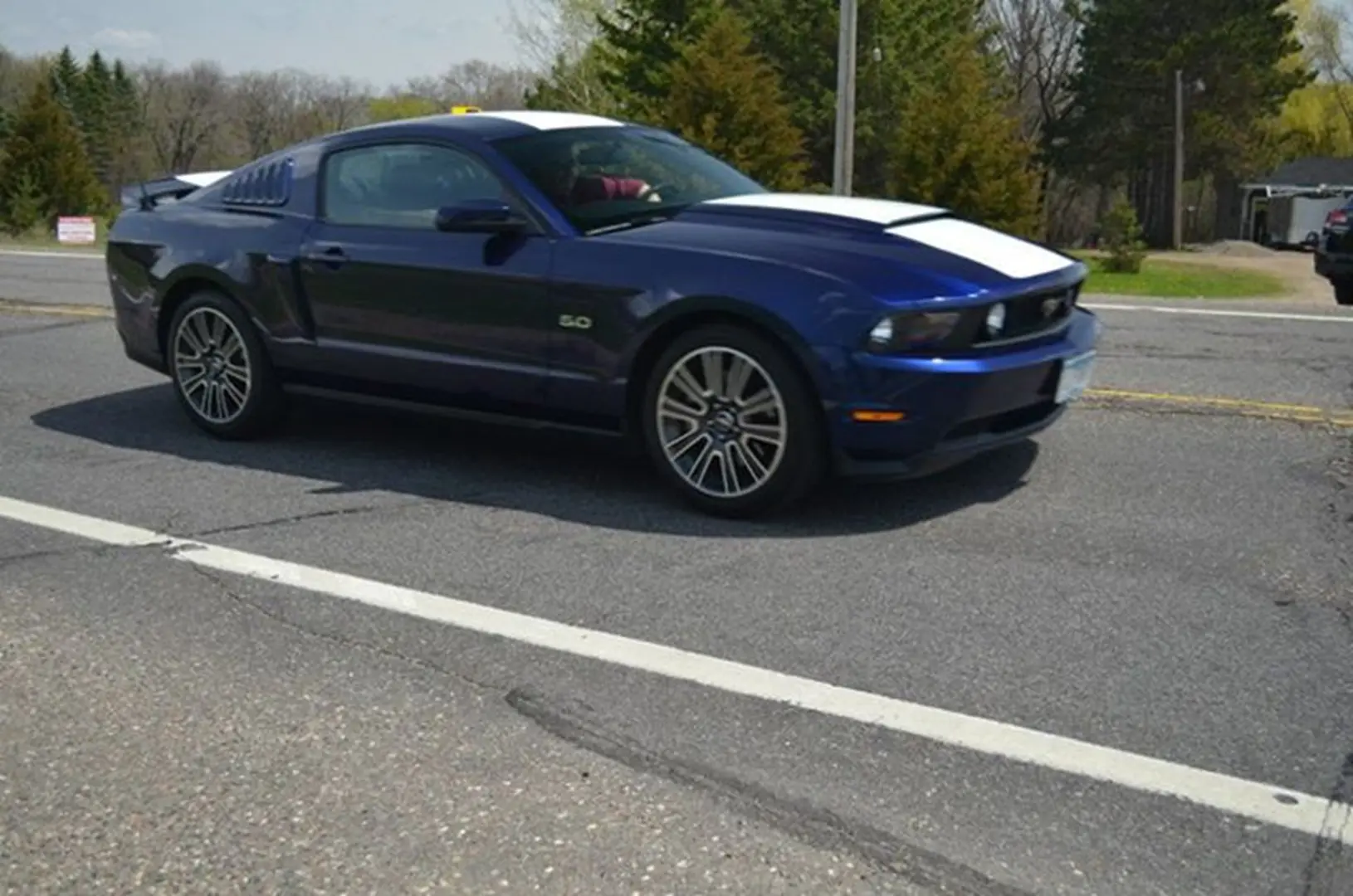 Blue sports car on rural road