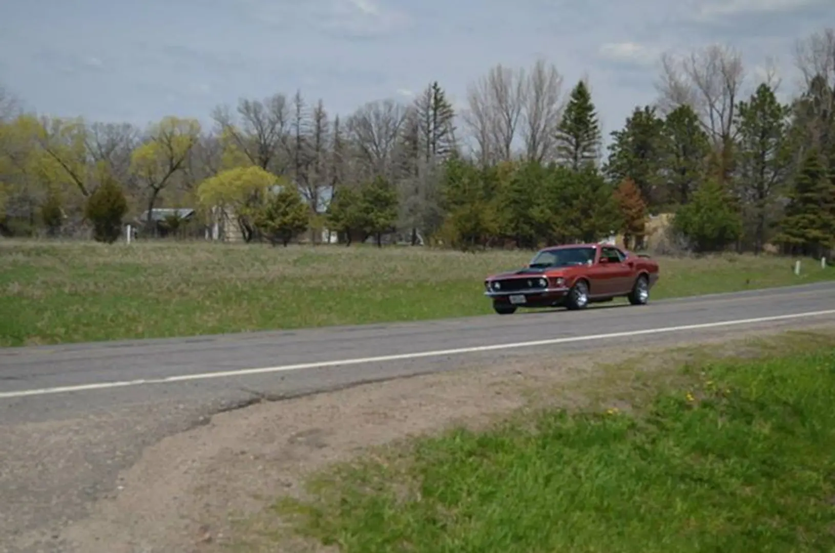 Classic car cruising along countryside