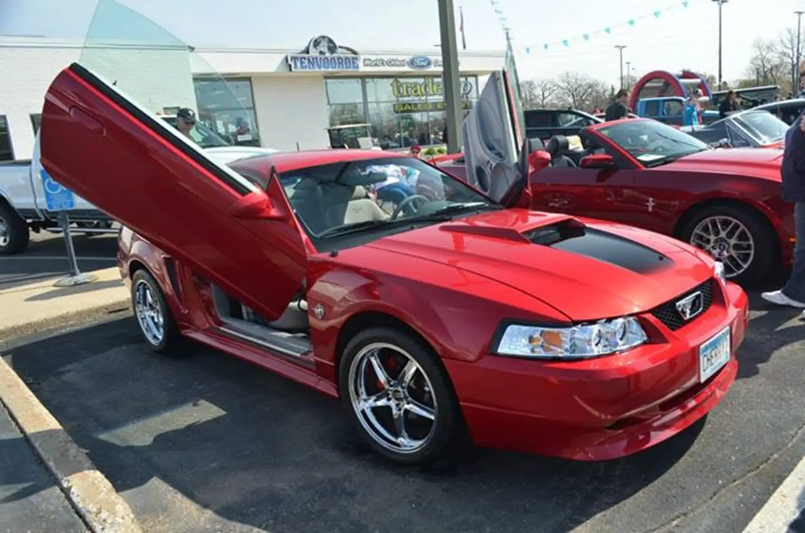 Red sports car with open scissor doors