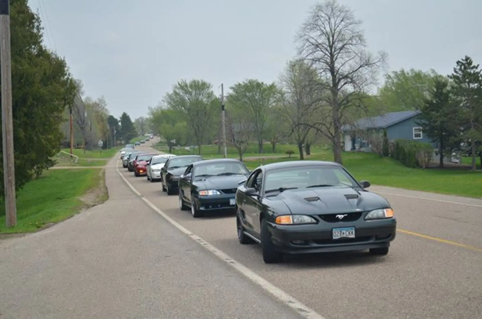 Convoy of cars on suburban street