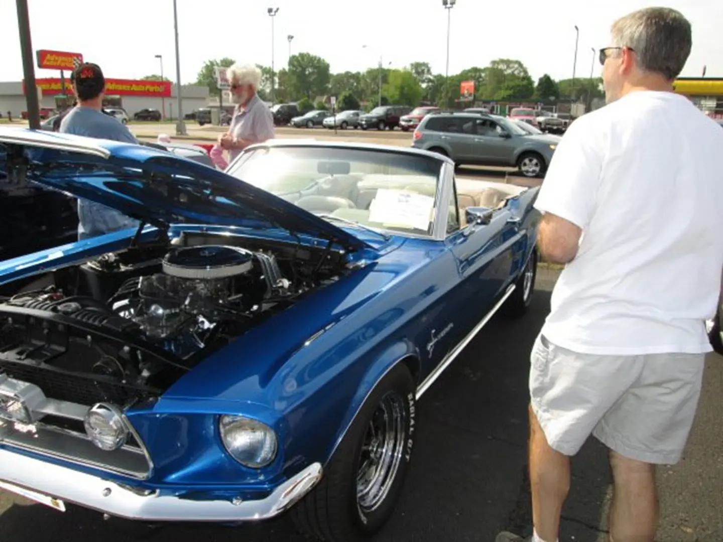 Open hood of classic blue car