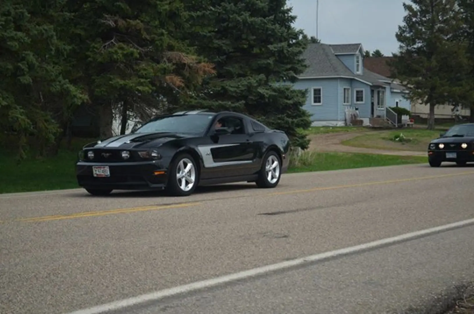 Two cars cruising in residential area