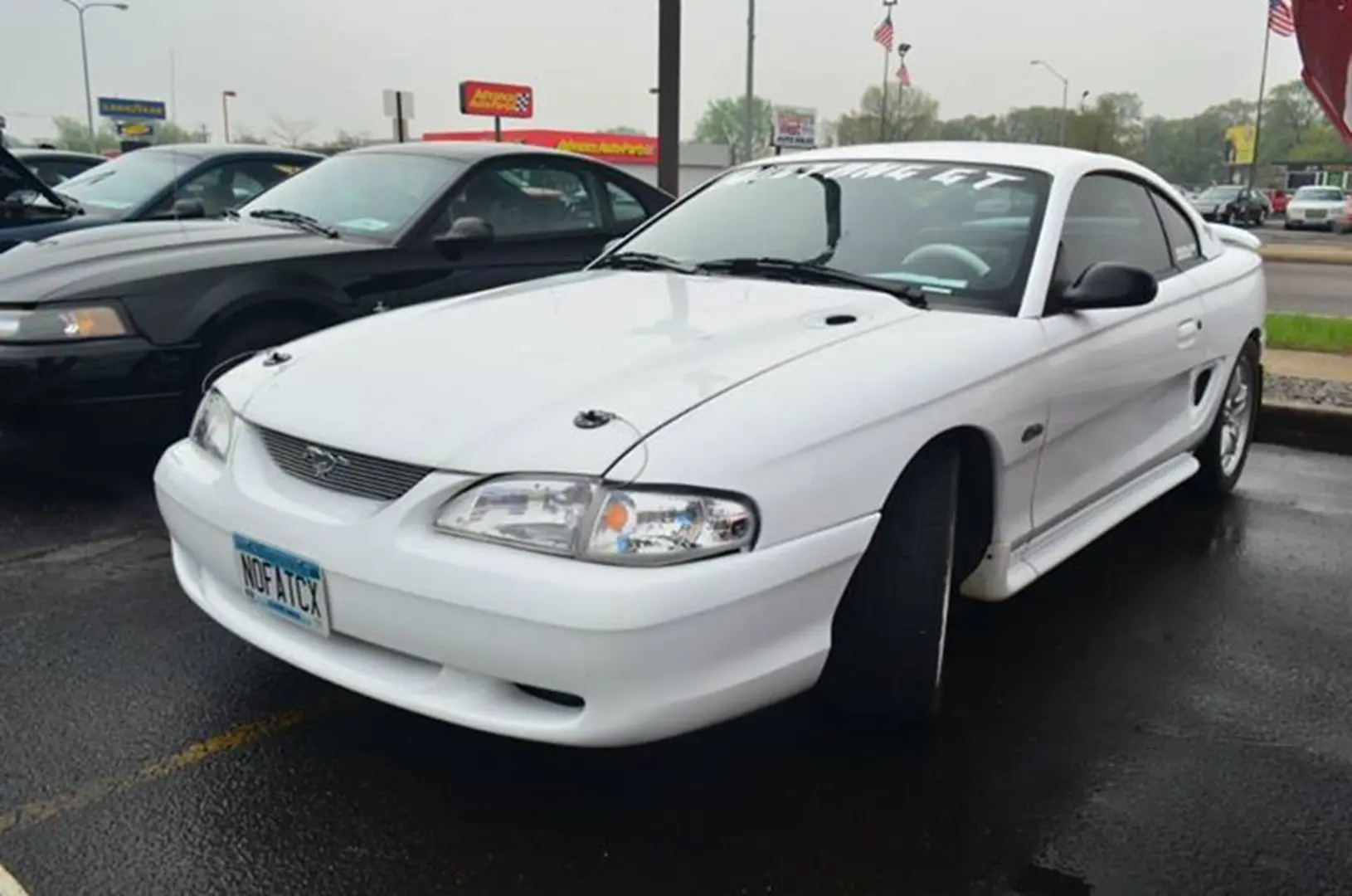 White sports car in parking lot