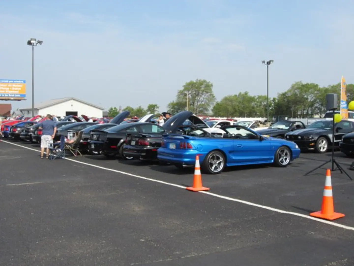 Blue convertible among parked cars