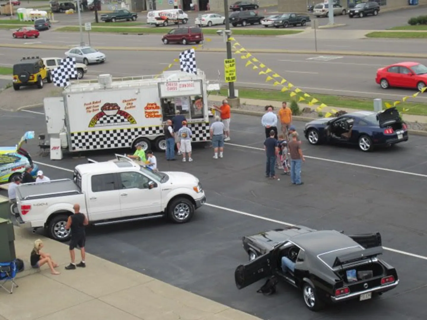 Food truck and classic cars displayed