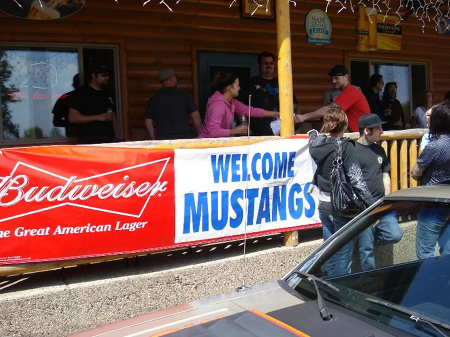 Crowd by Budweiser sign at event