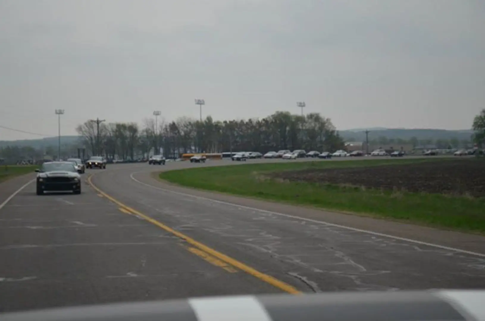 Vehicles traveling near green fields