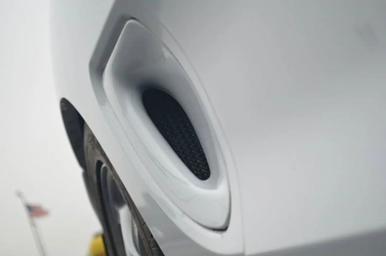 White car with visible exhaust vent
