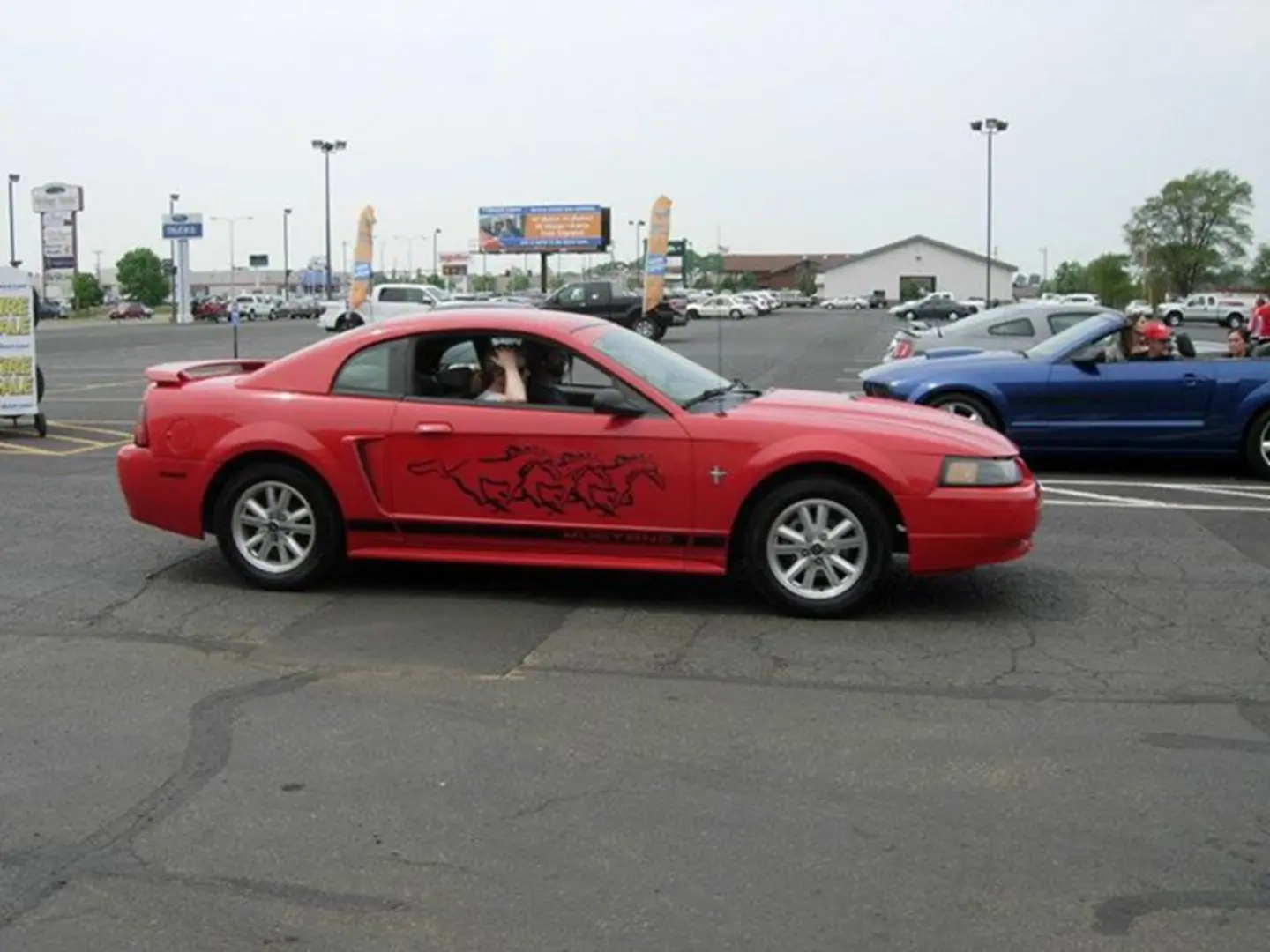 Red car with horse decals