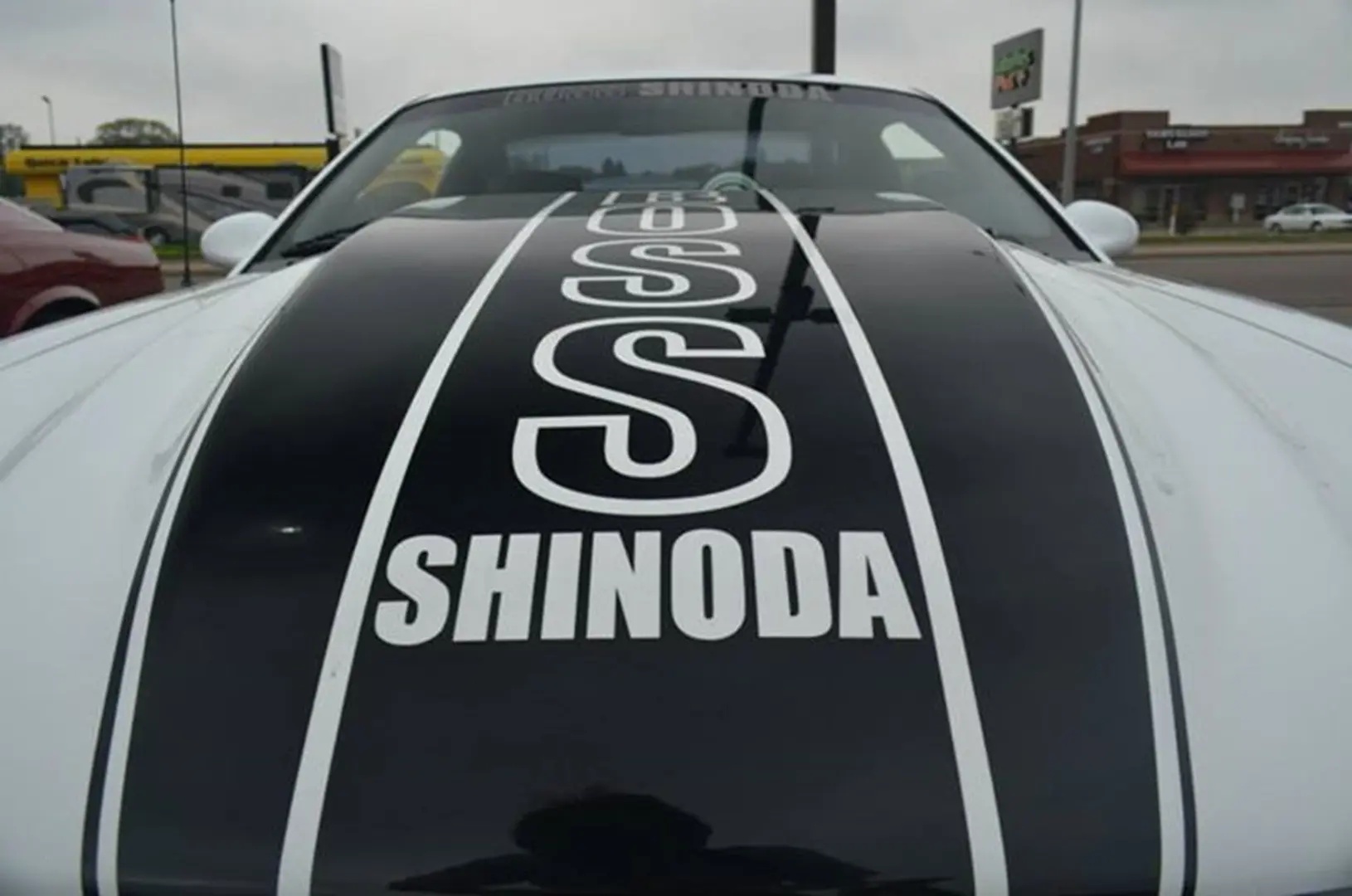 Car with "SHINODA" text on hood