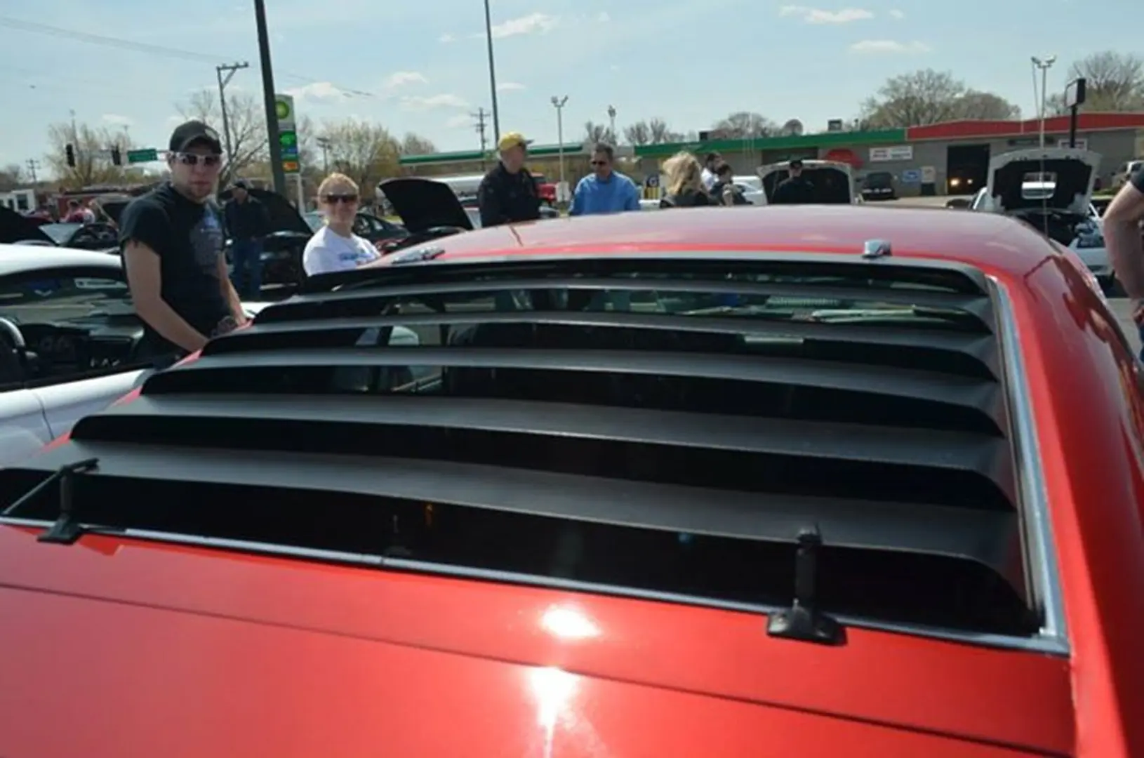 Car enthusiasts at outdoor auto show
