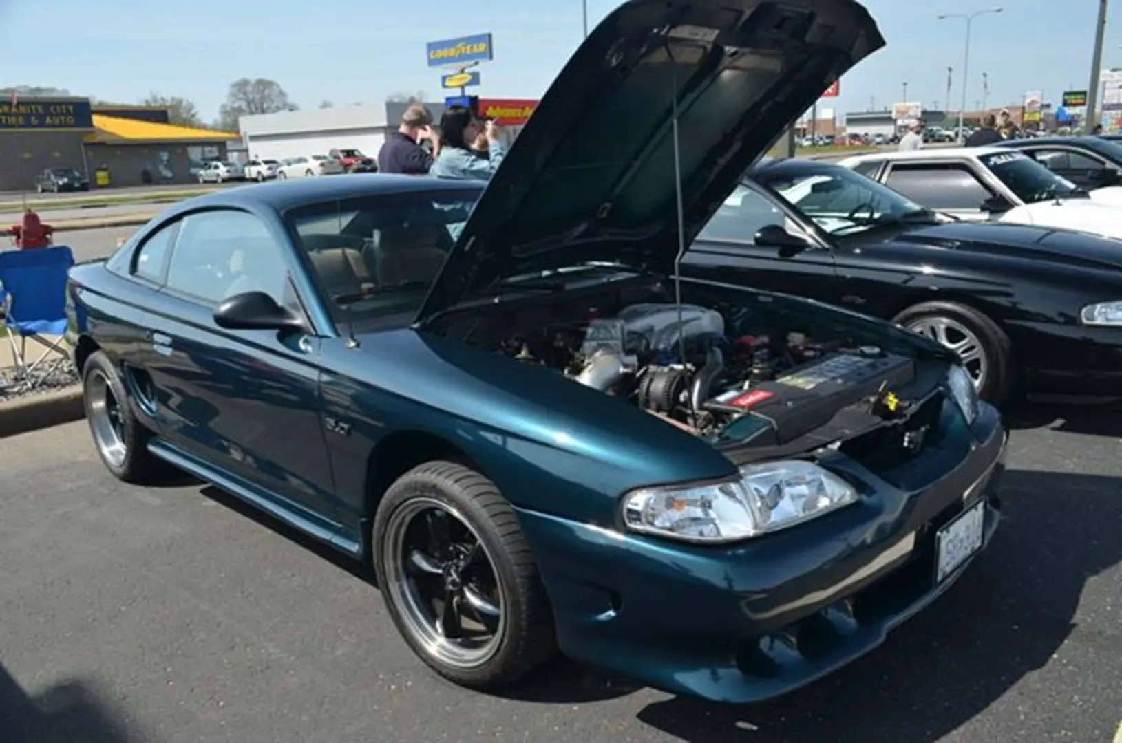 Blue sports car with hood open
