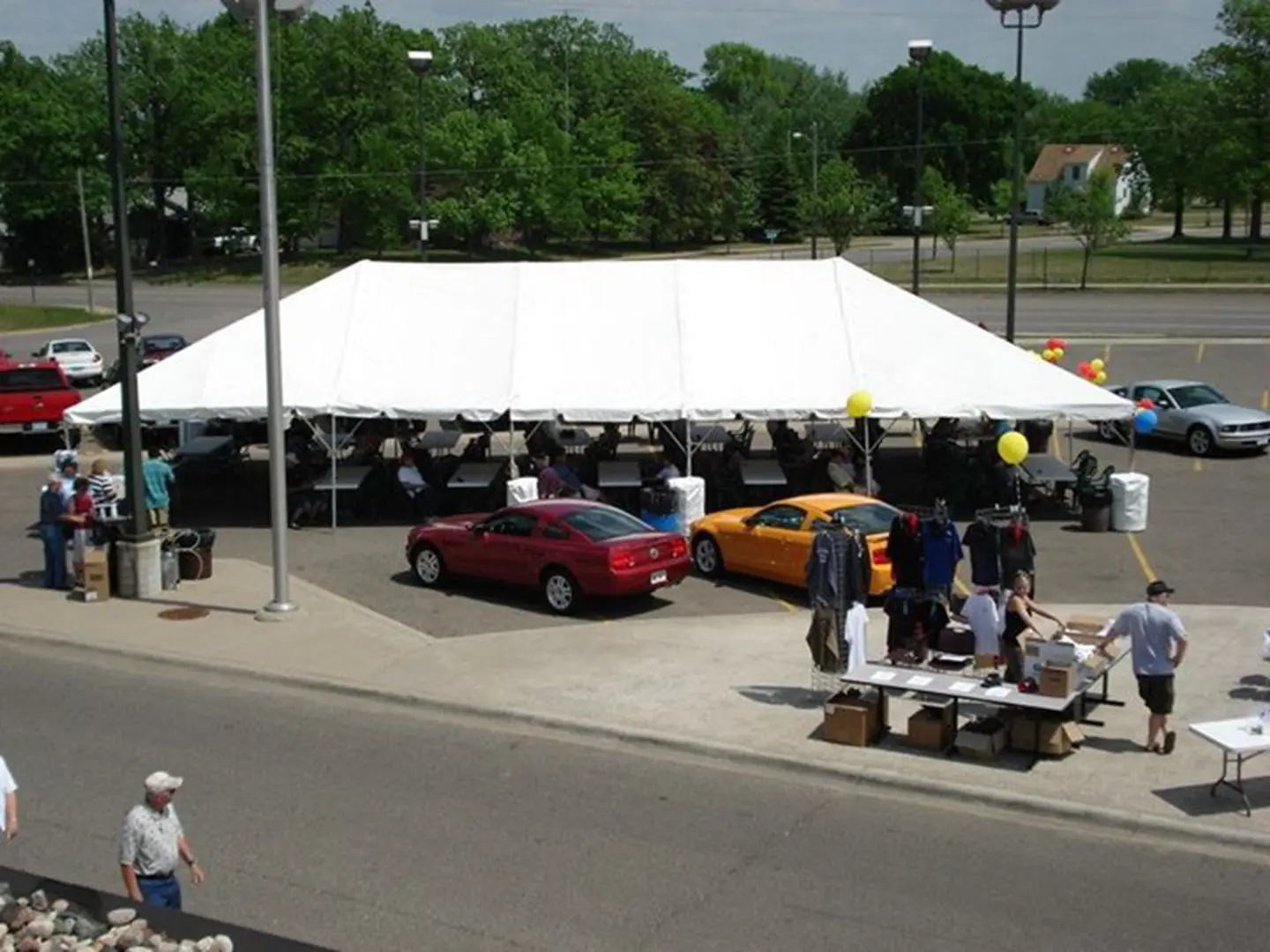 Outdoor car sale under a large tent