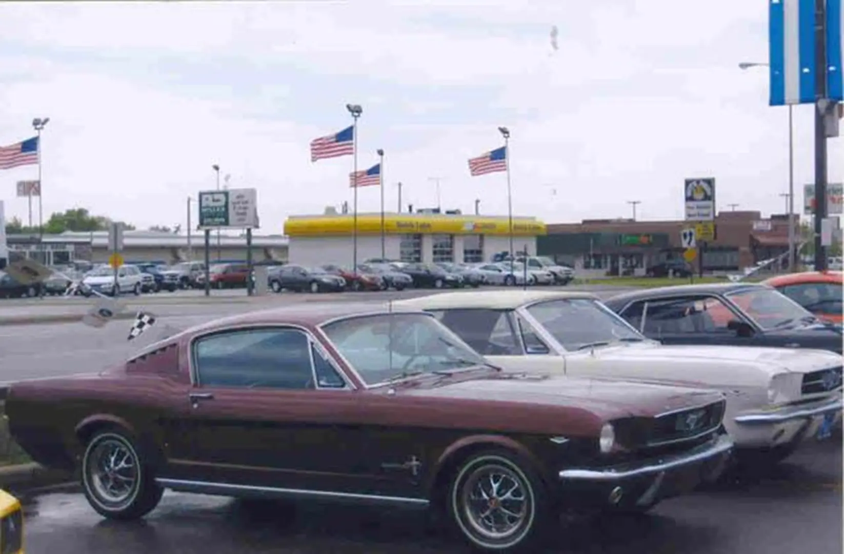 Classic cars with American flags in background