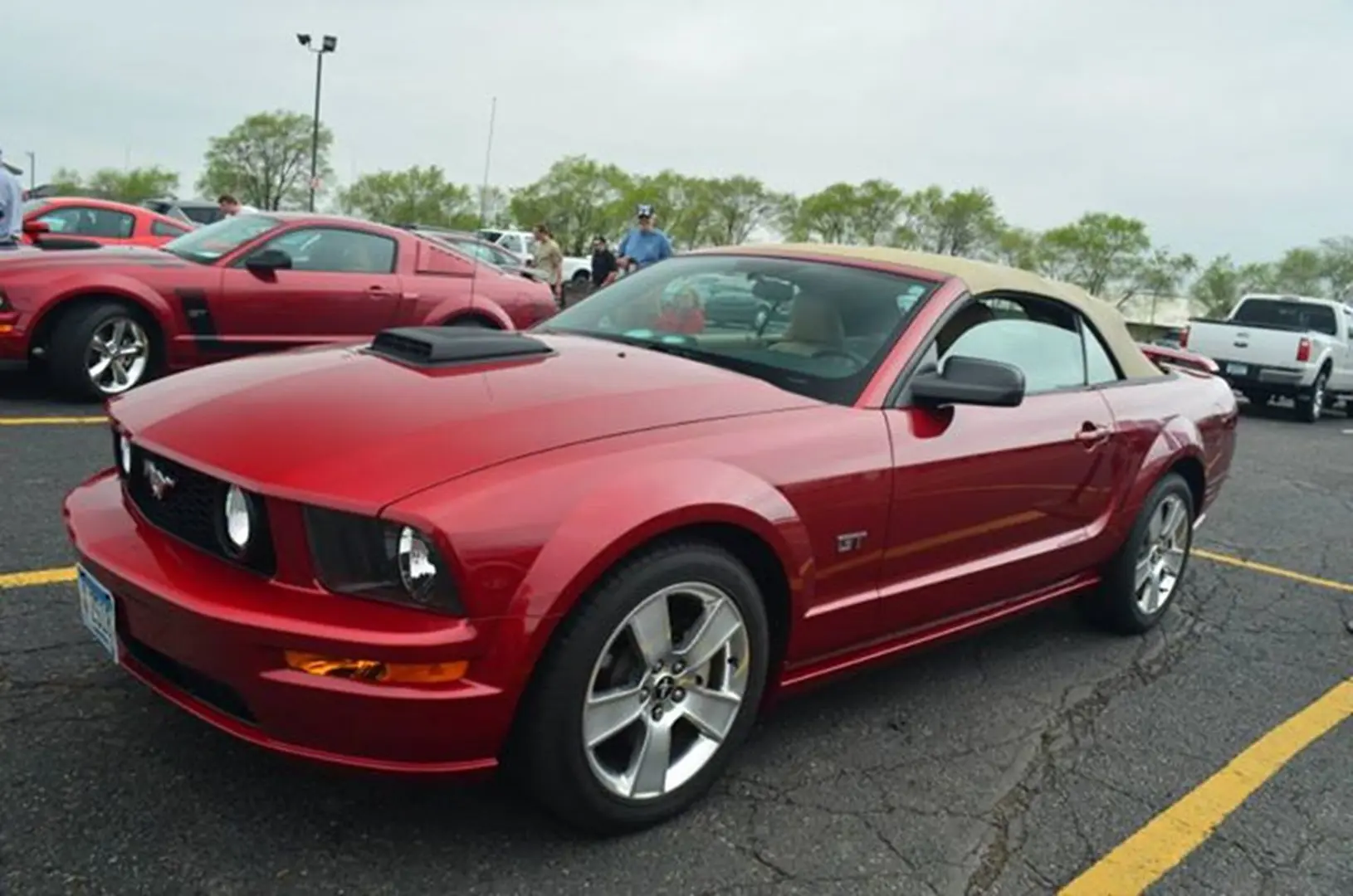 Red convertible Mustang at car show