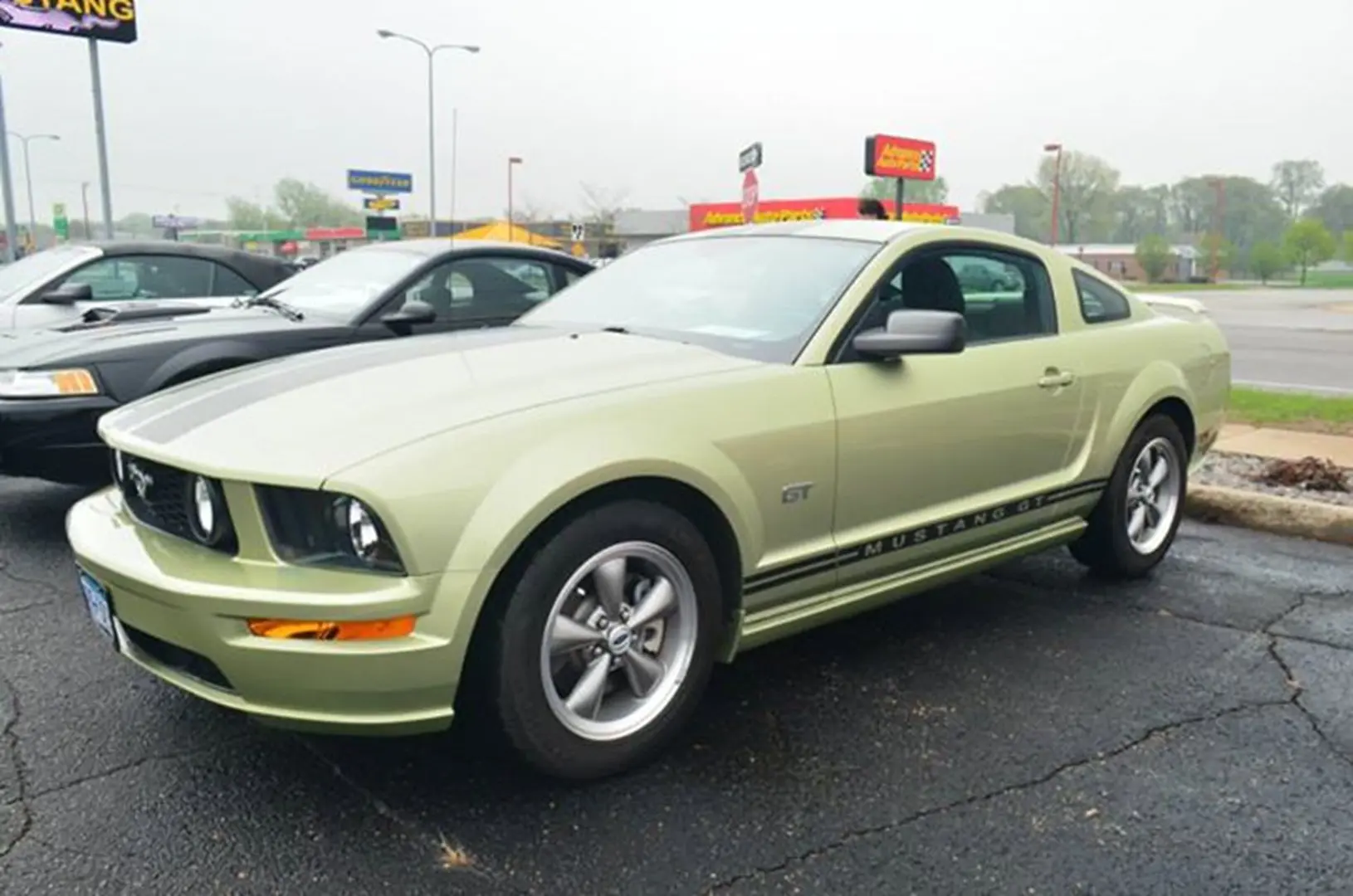 Green sports car in parking lot