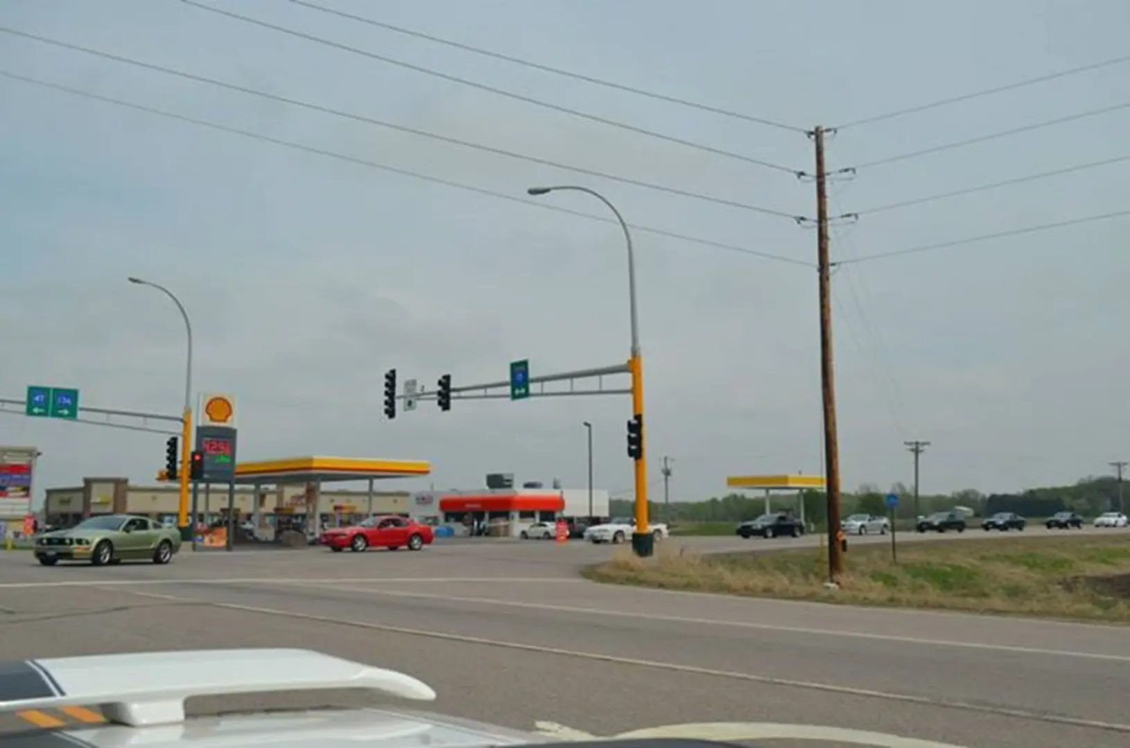 Gas station and cars at road intersection