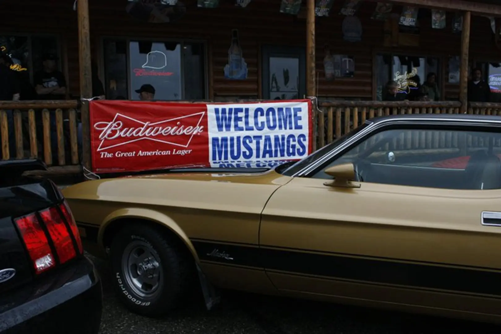 Classic car beside wooden building
