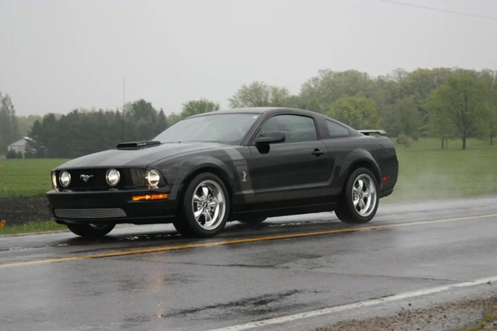 Sleek car cruising on countryside road