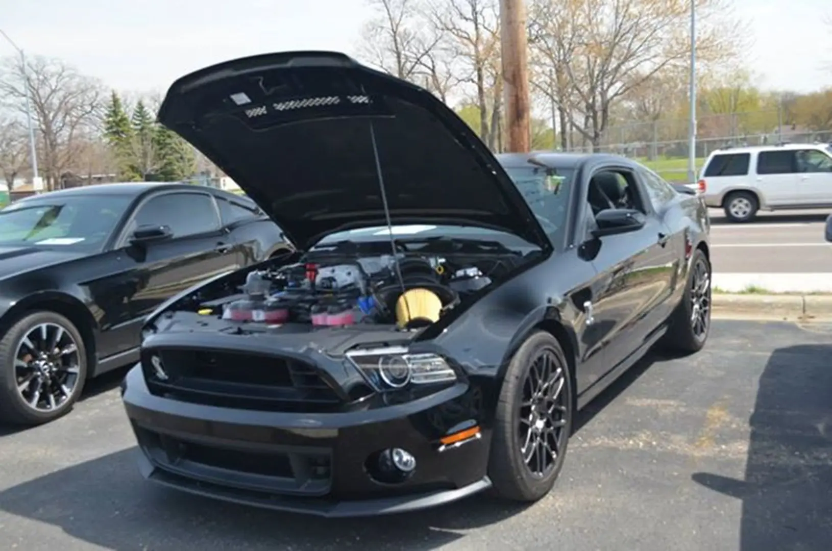 Black vehicle parked with engine visible