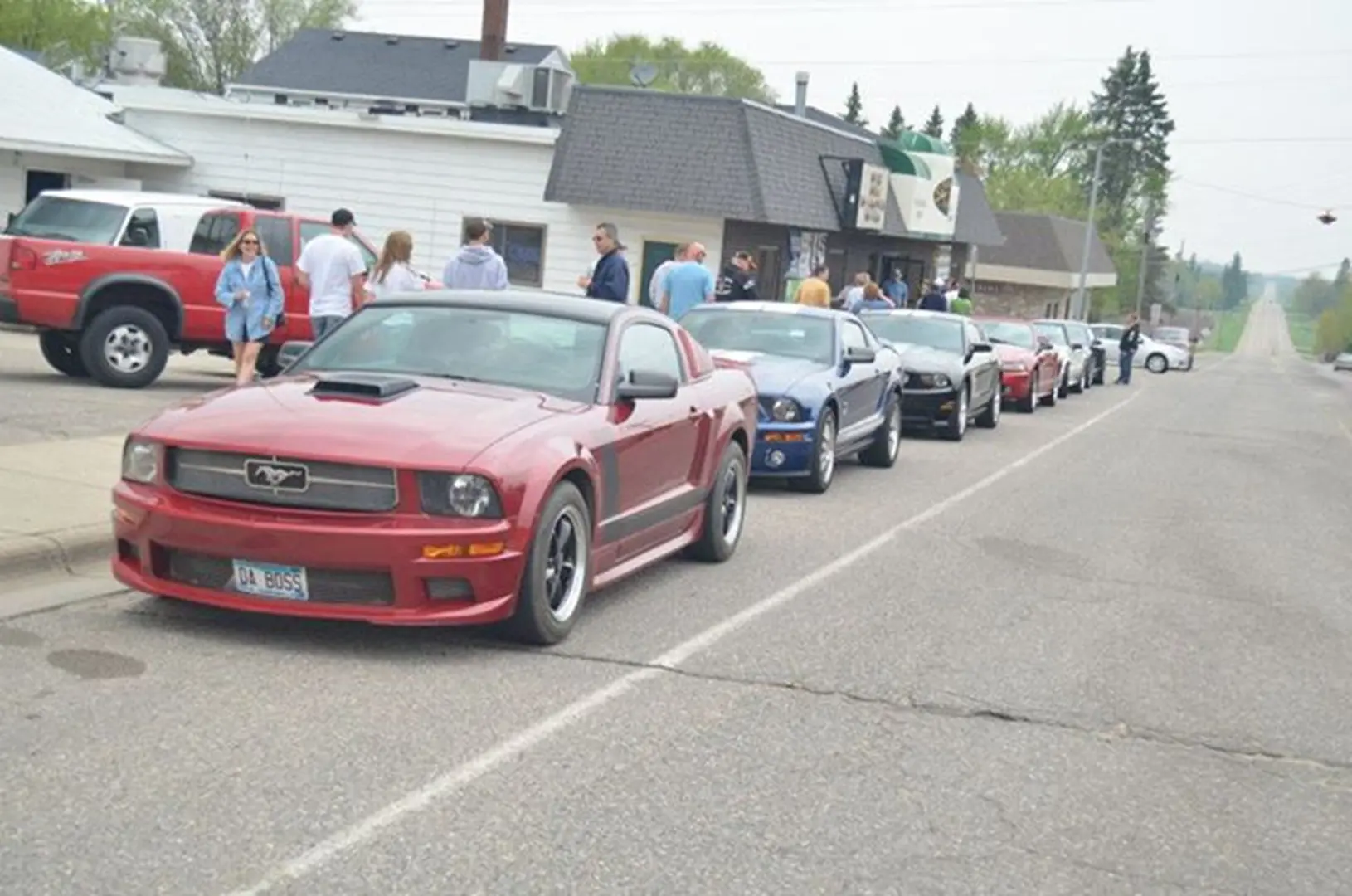 Line of colorful cars parked roadside