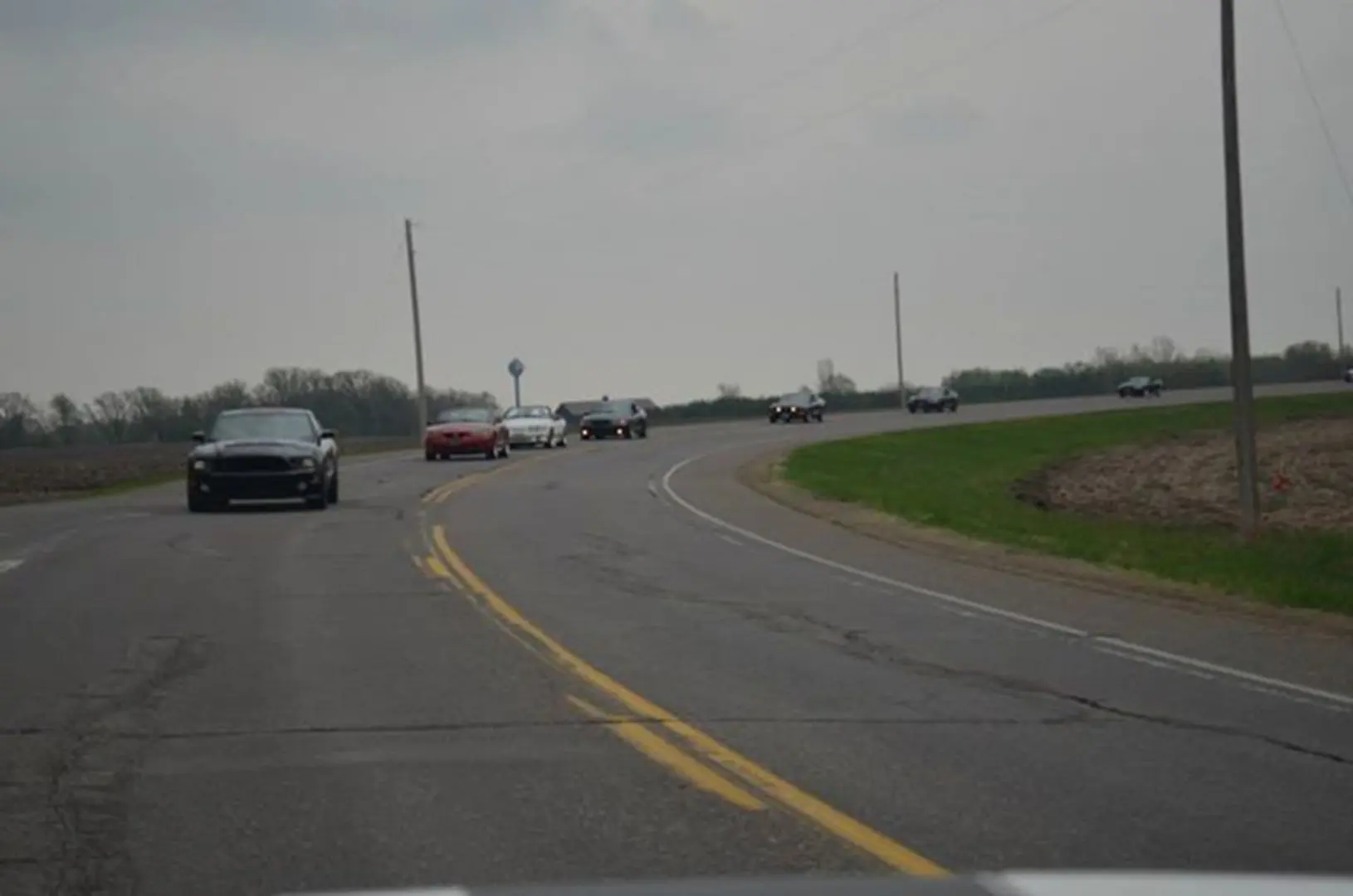 Cars rounding a curve in countryside