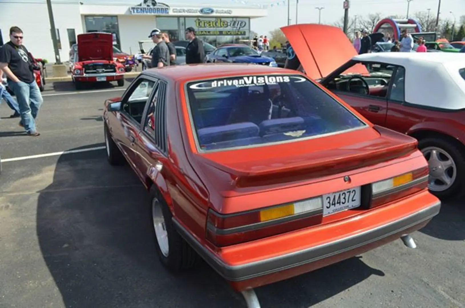 Red classic car at a car show