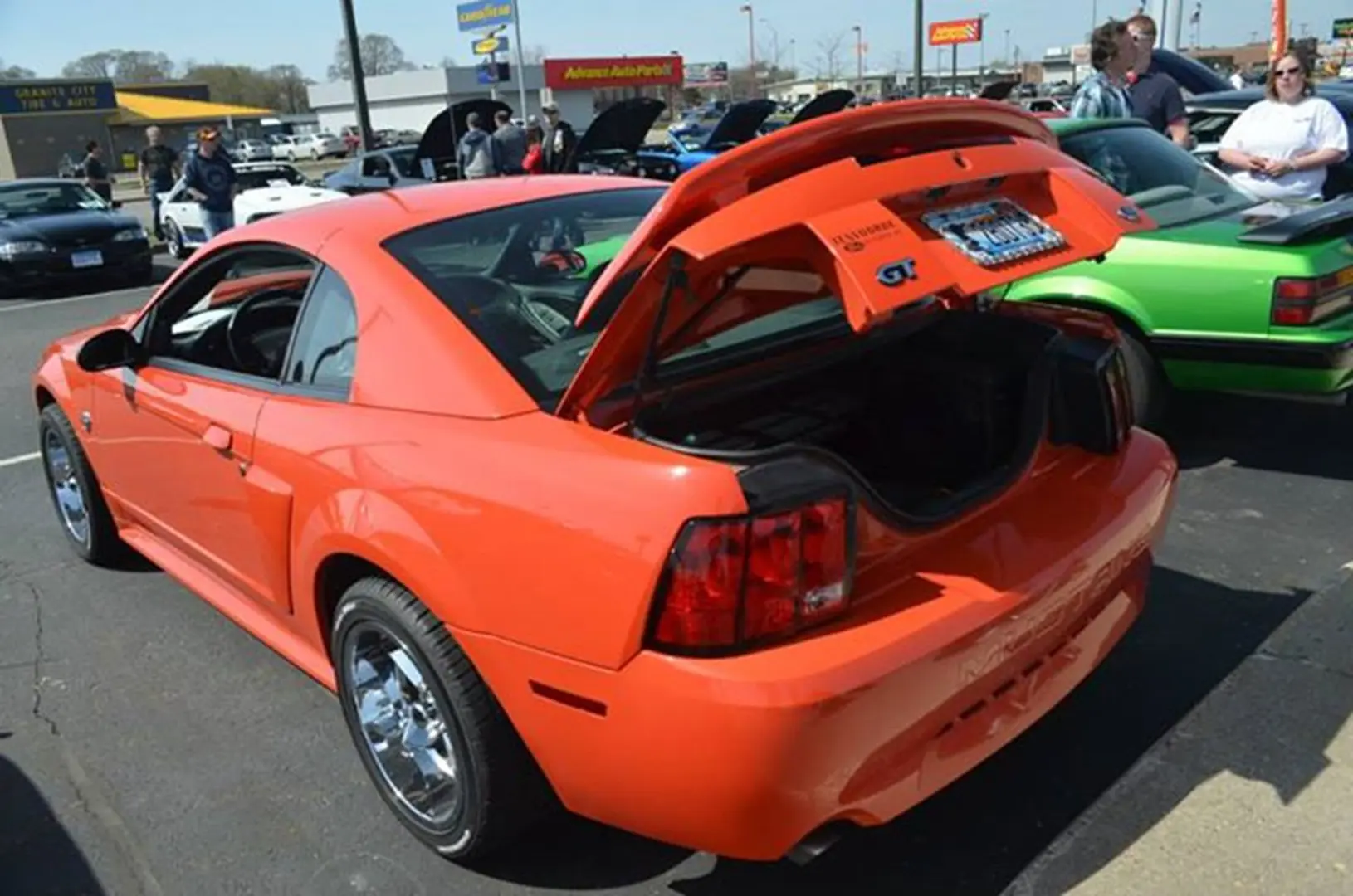 Bright orange car displayed outdoors