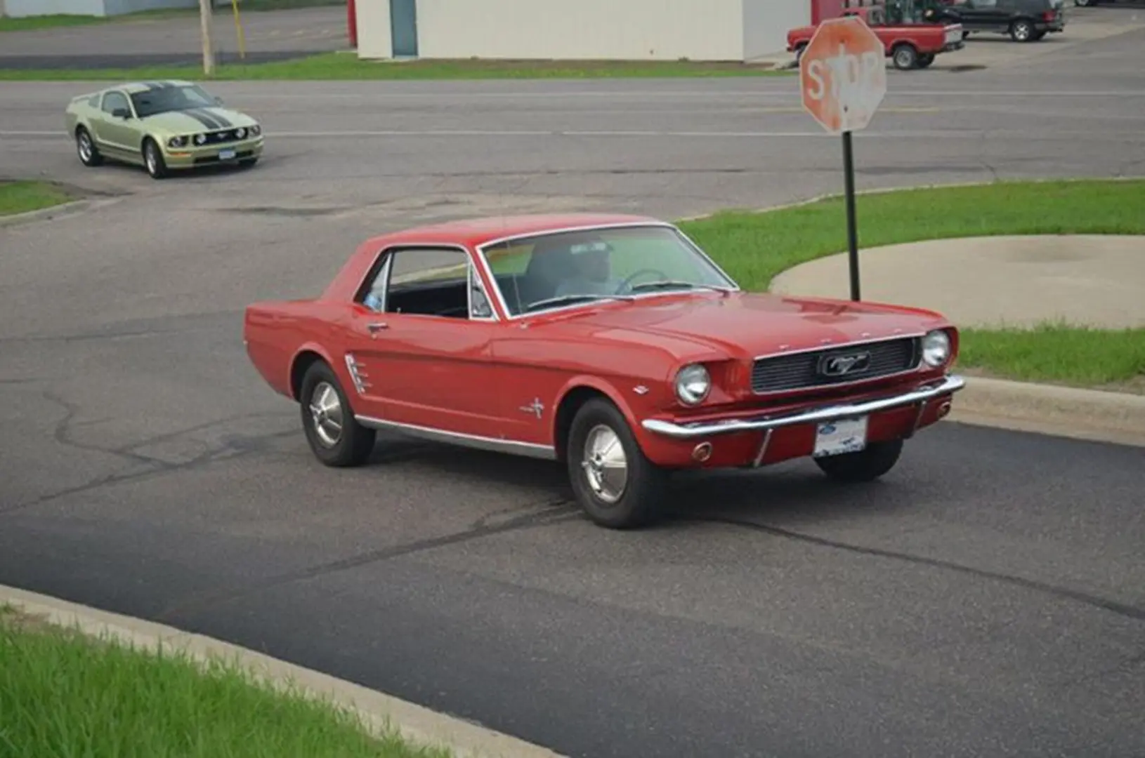Vintage Mustang cruising with green car behind