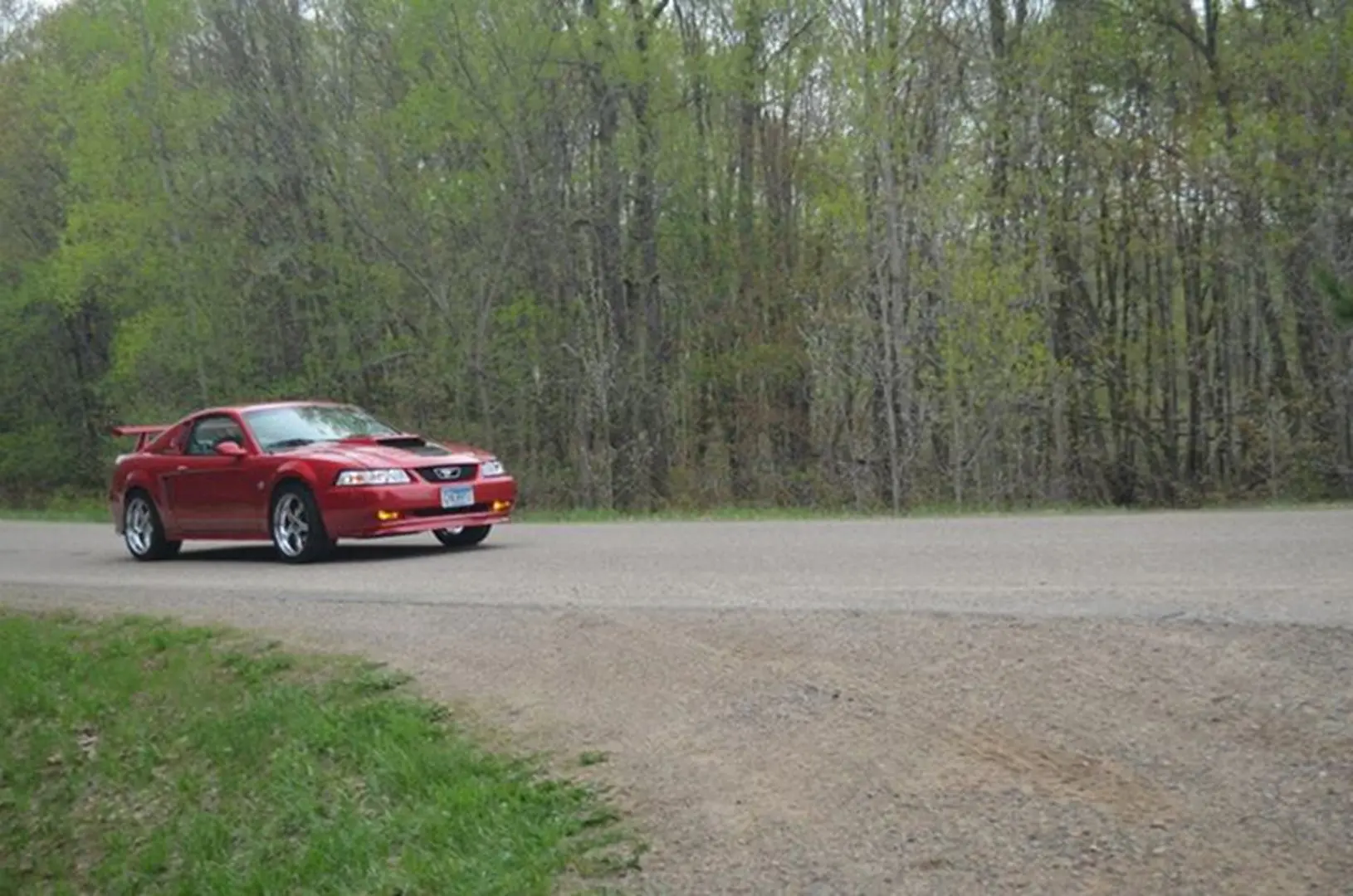 Red vehicle on winding country road