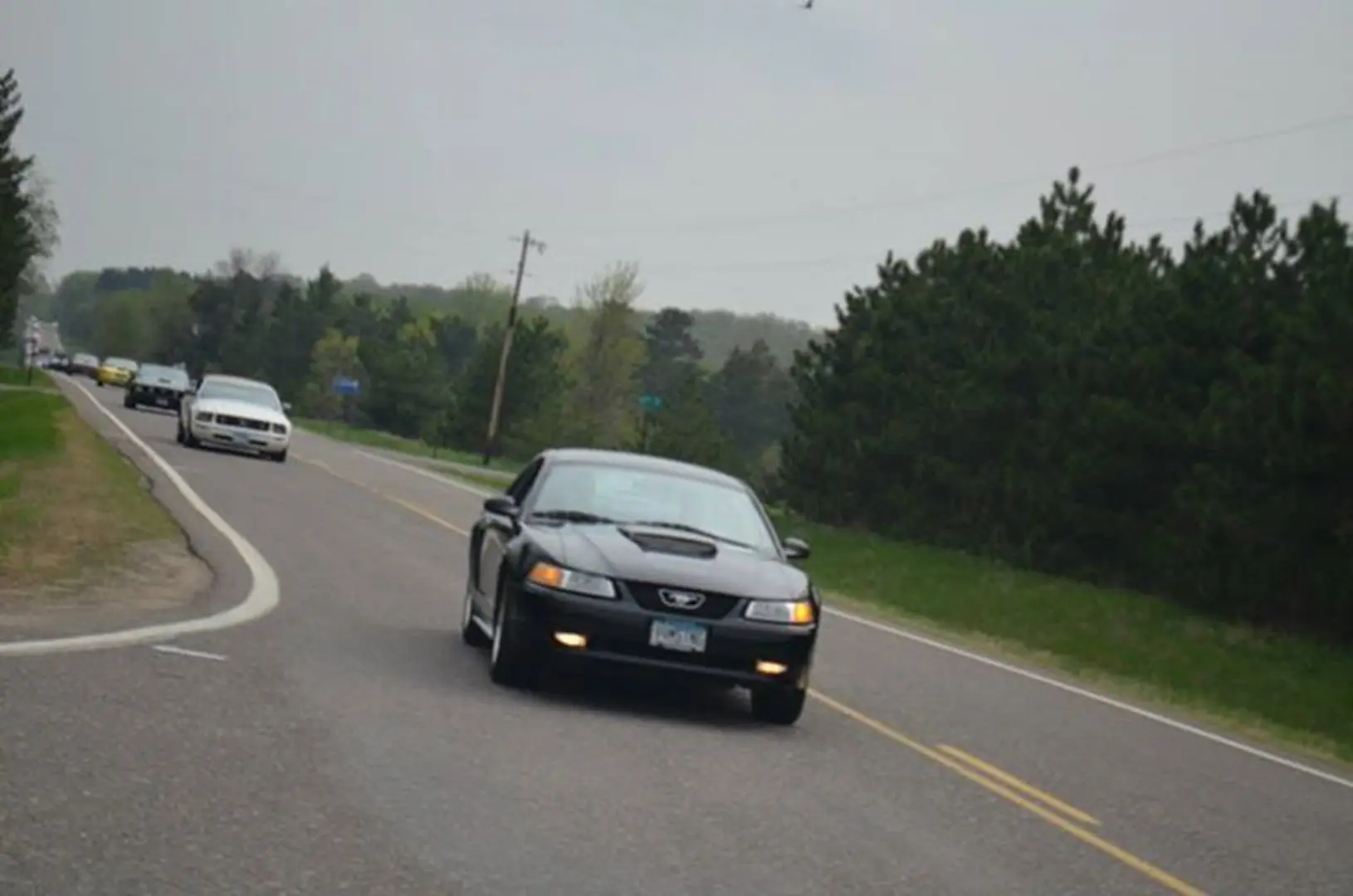 Black car driving on rural road