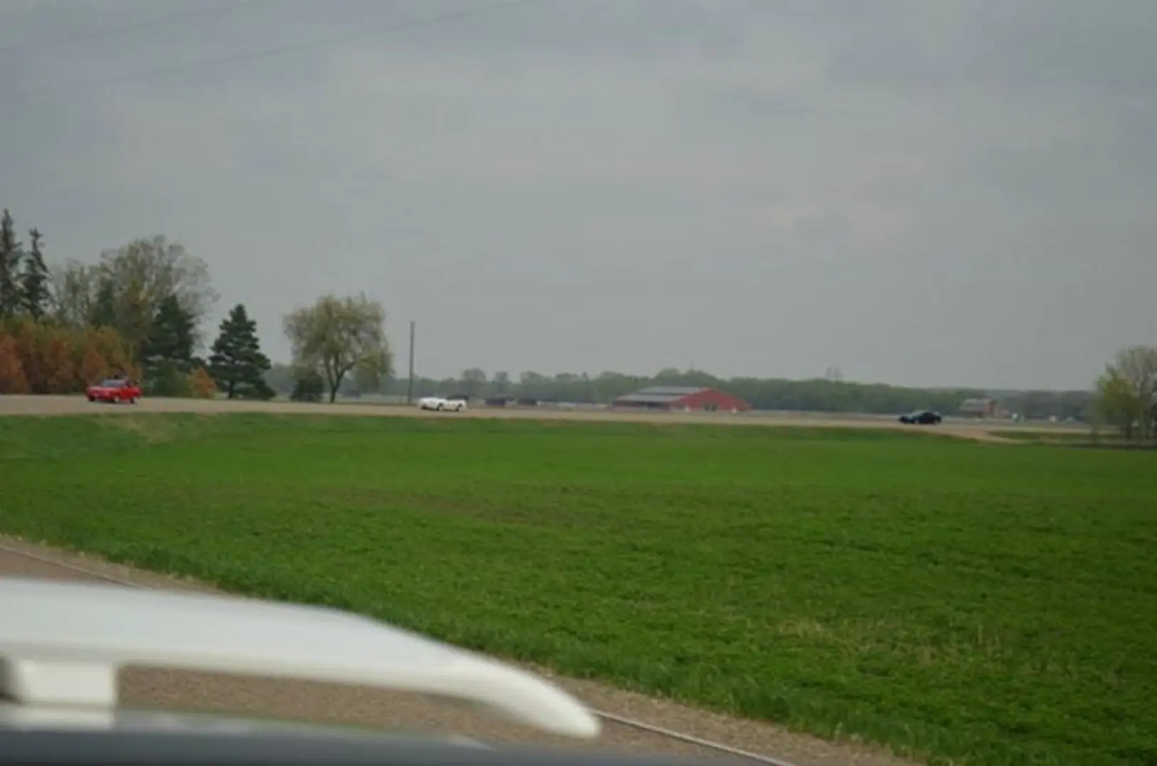 Green field under cloudy sky