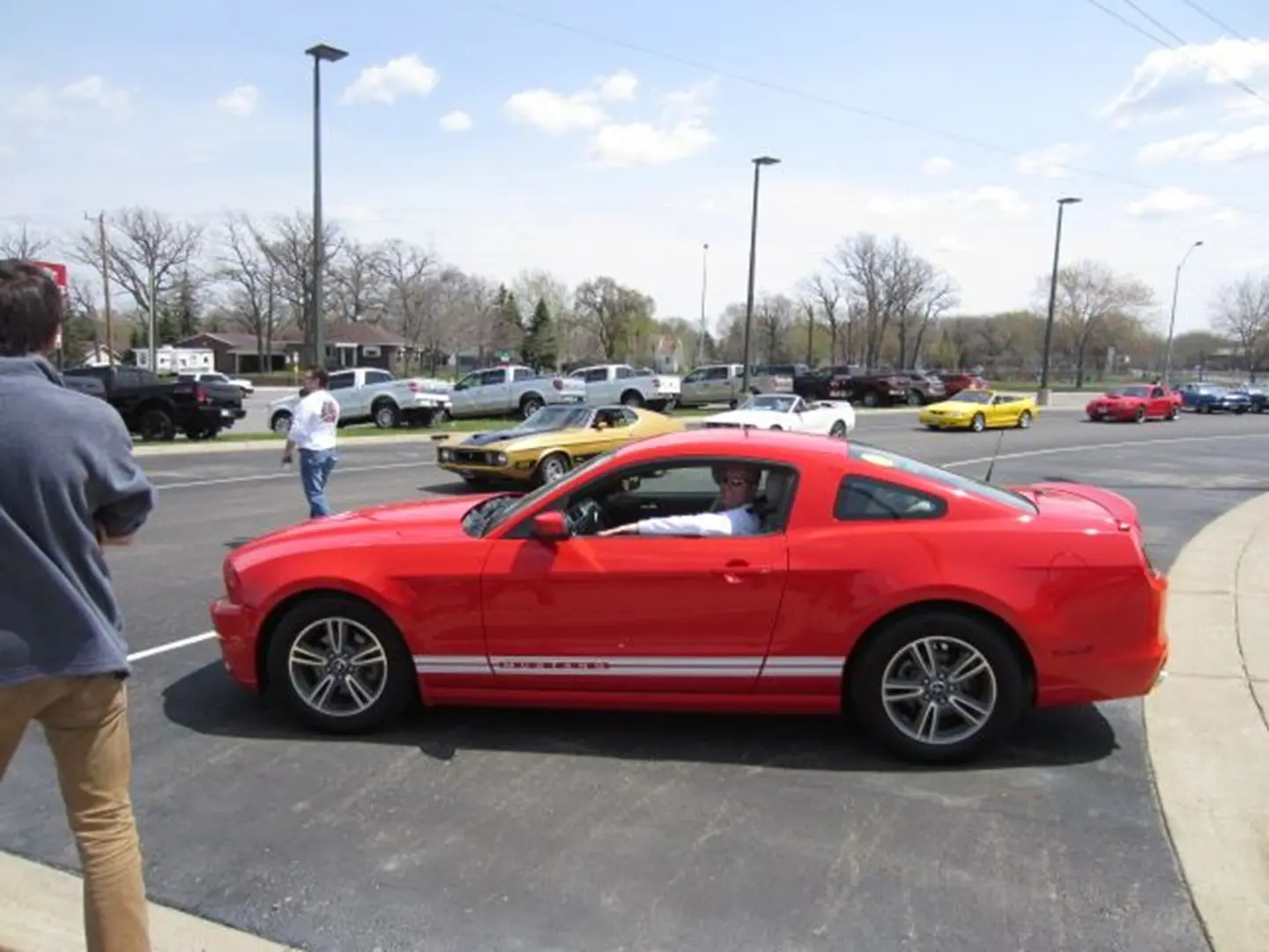 Man in red car at outdoor event