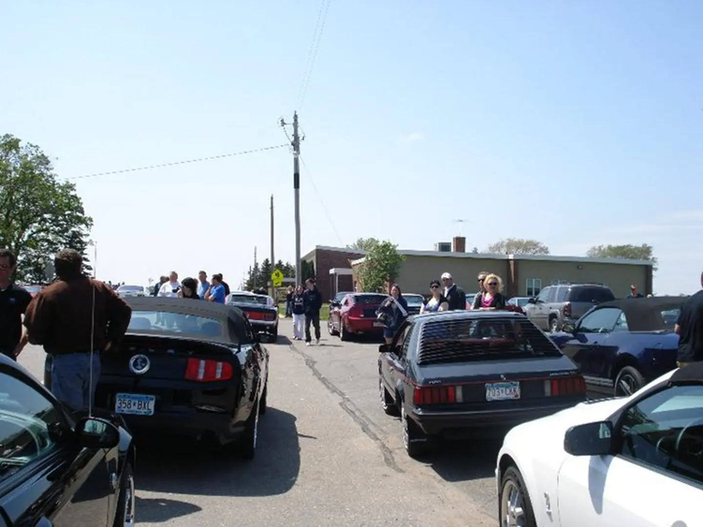 Car enthusiasts meet on sunny day