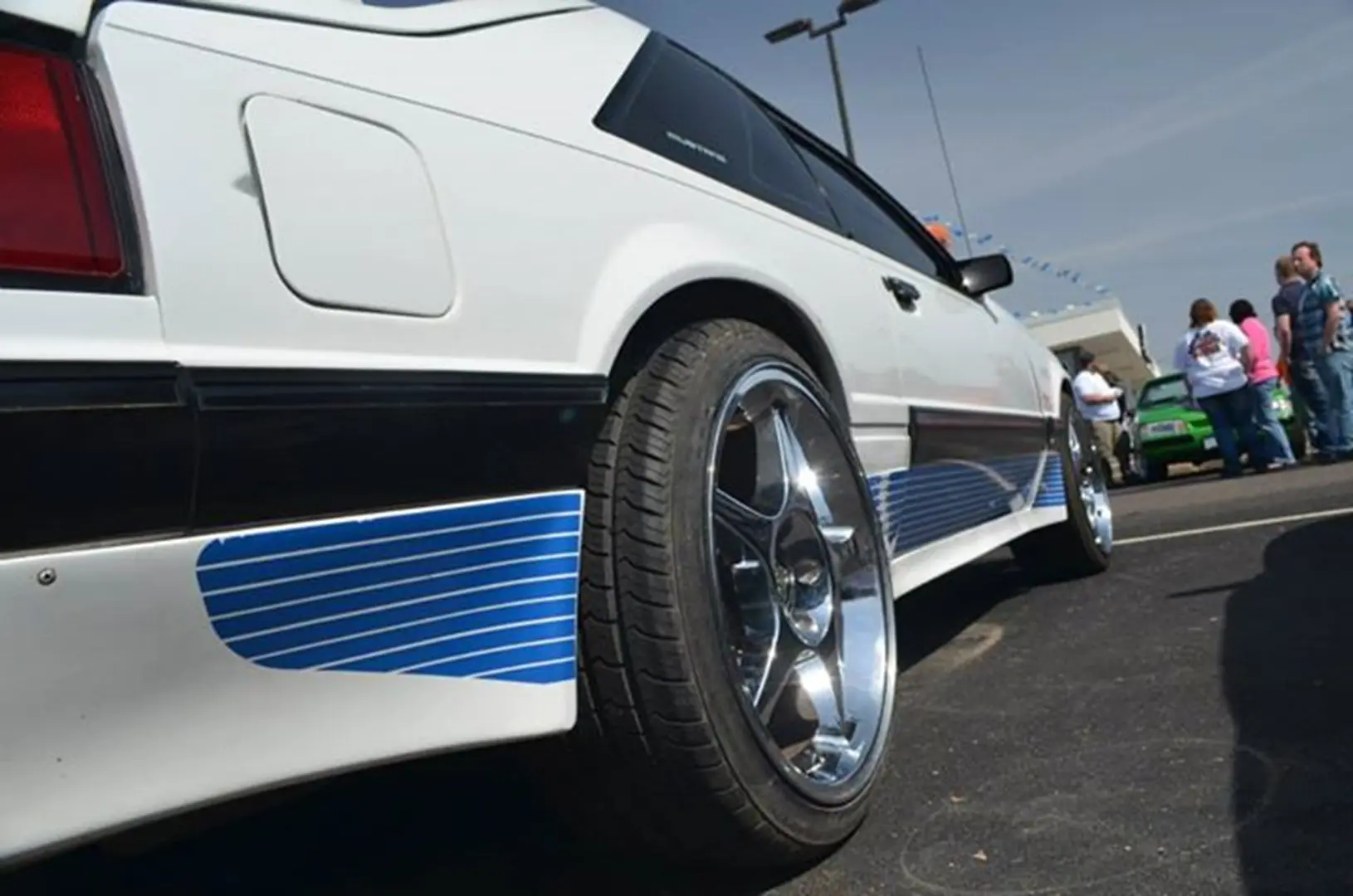 White sports car with chrome wheels