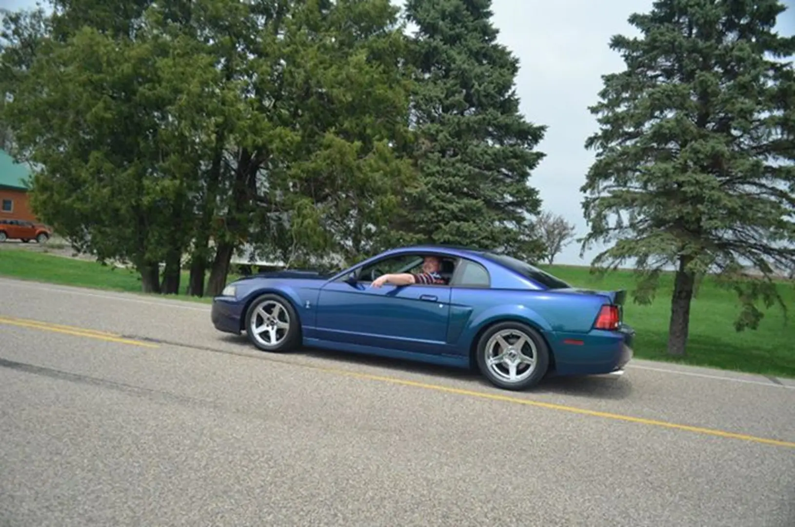 Blue Mustang on a scenic drive