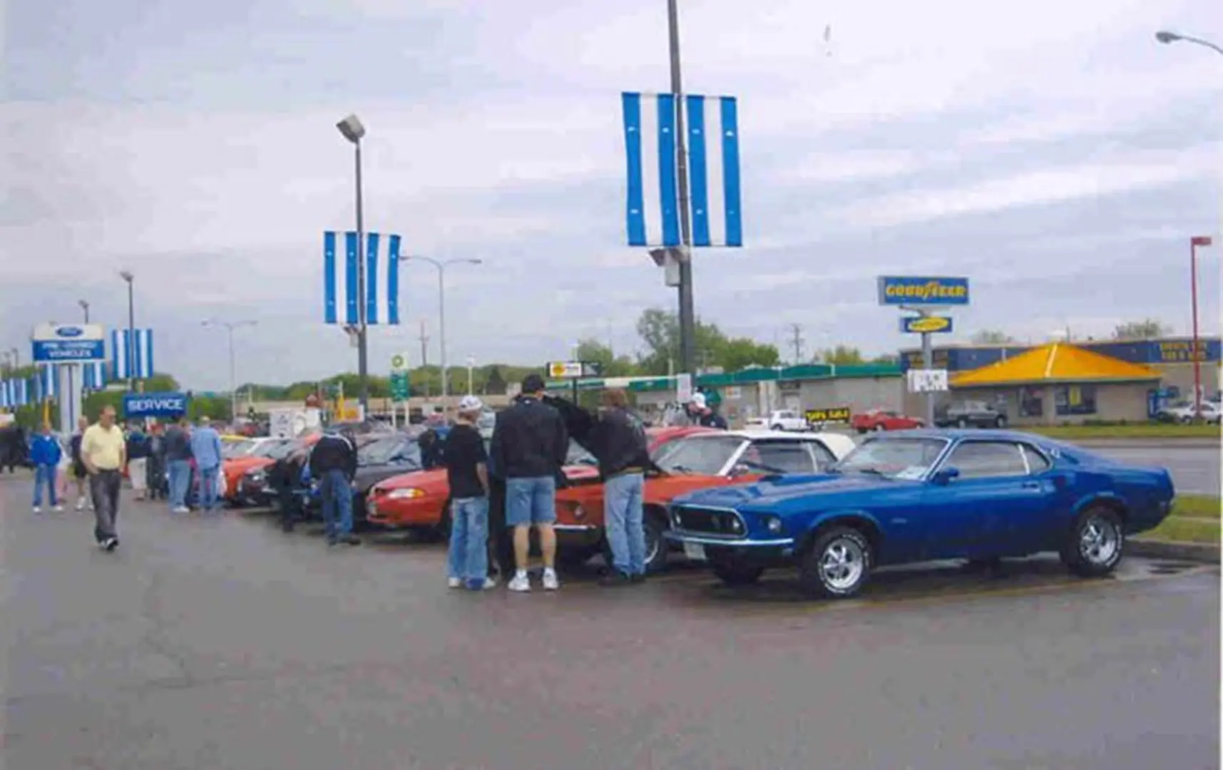 Classic cars lined up in parking lot