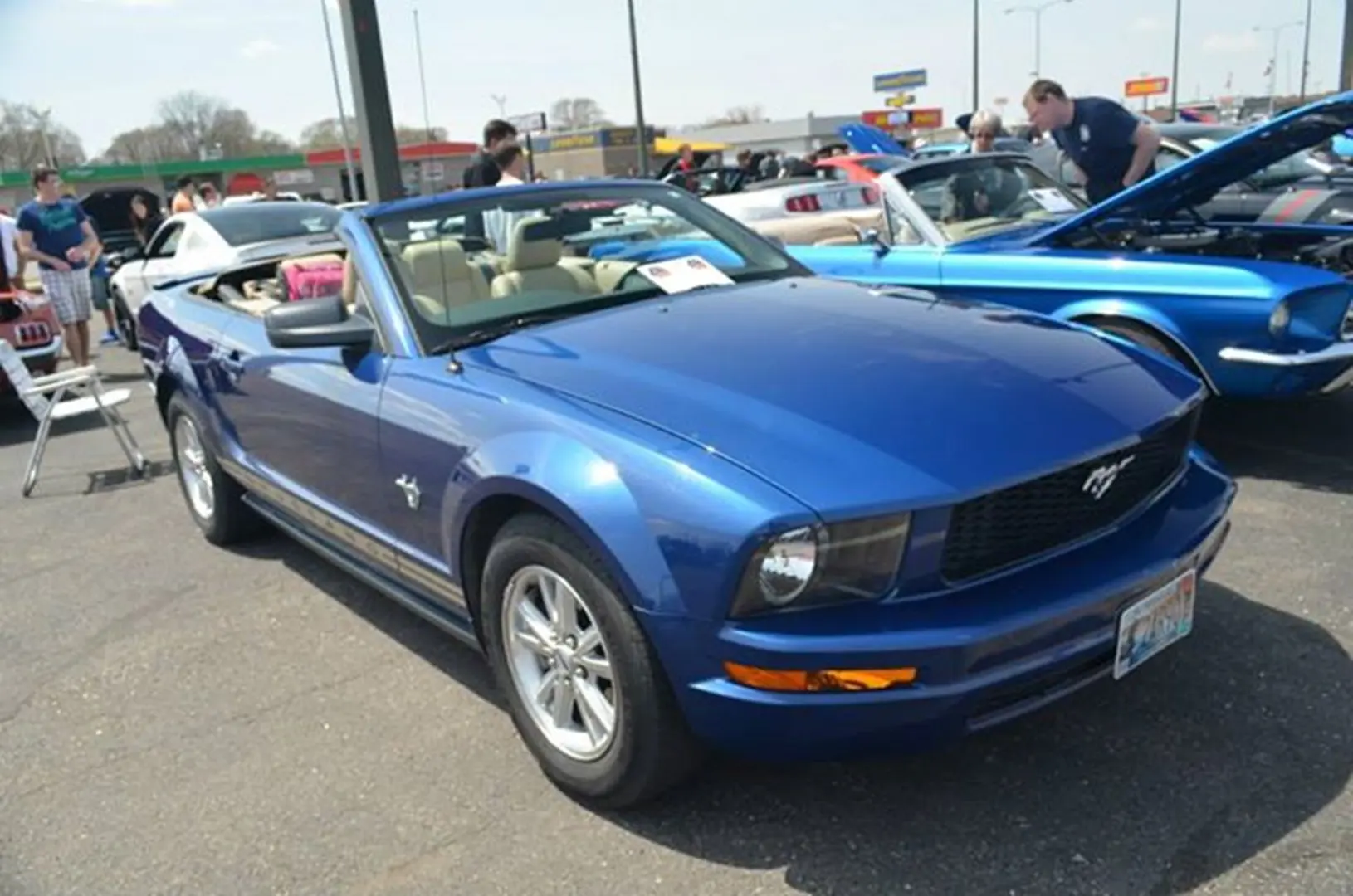 Blue convertible car at a car show