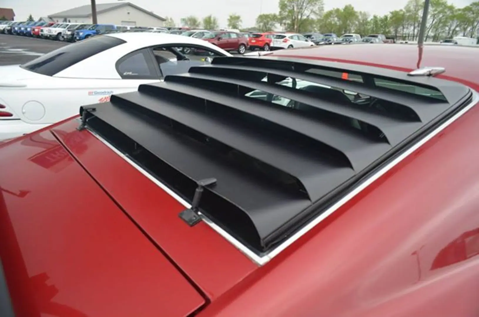 Red car with rear window louvers